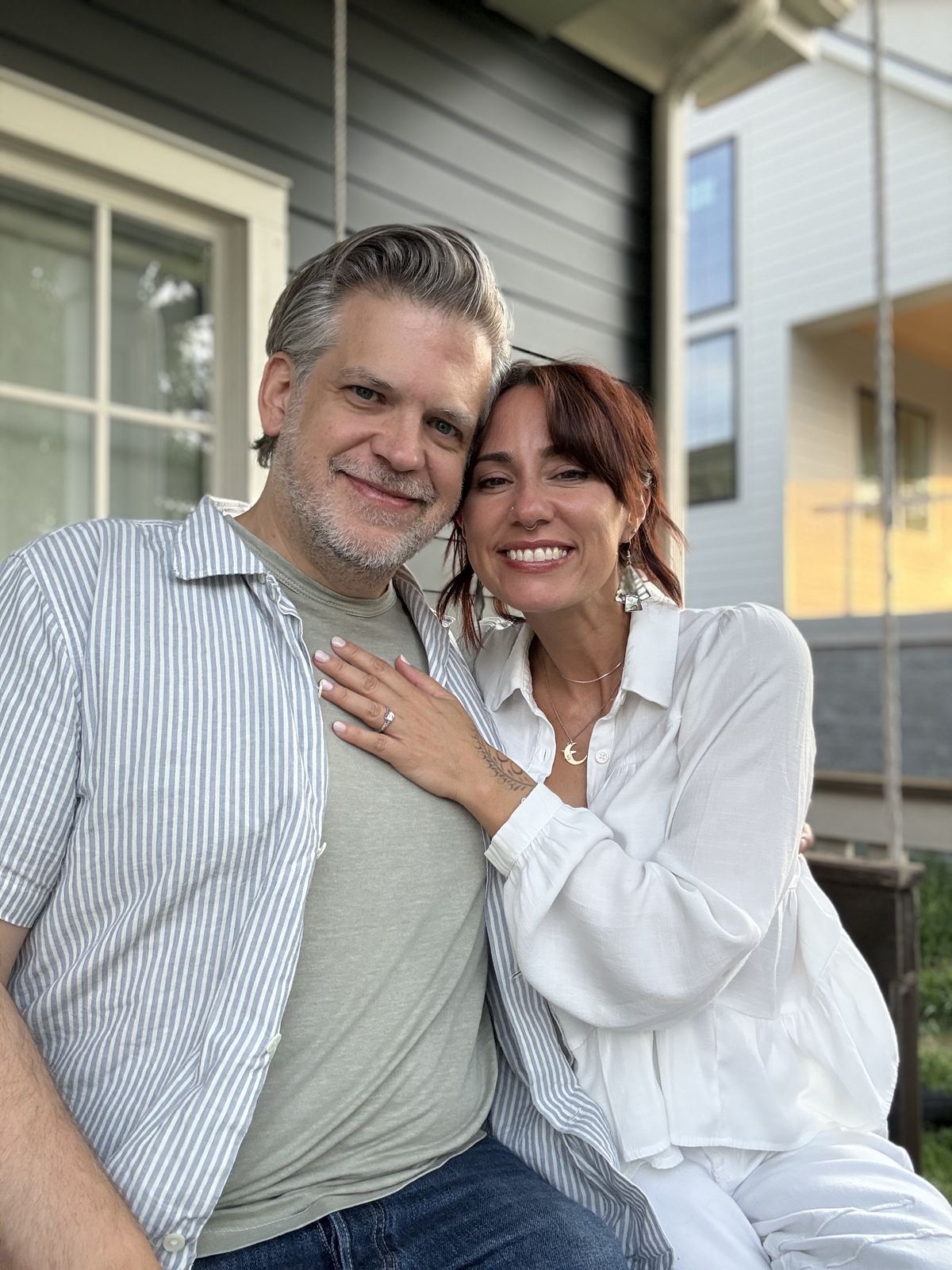 Danielle and Patrick embracing on a porch